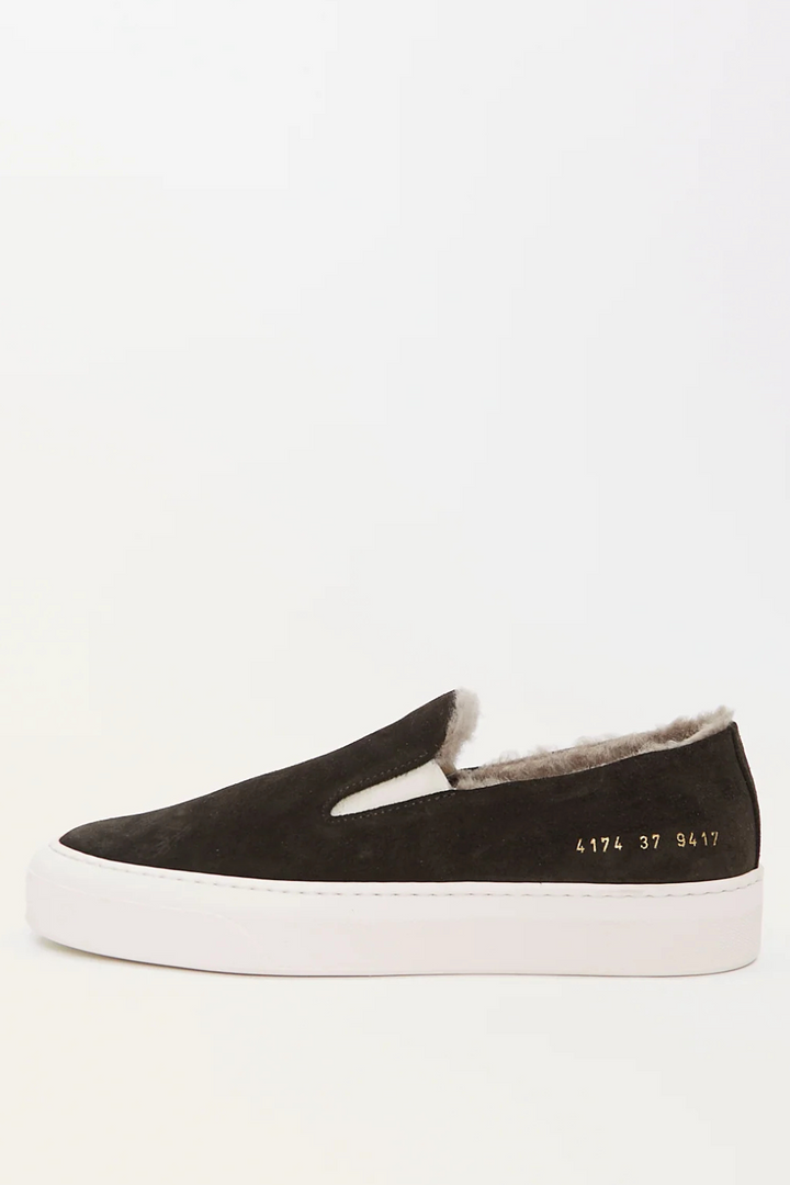 Flat lay of Common Projects Slip On In Suede With Shearling side view