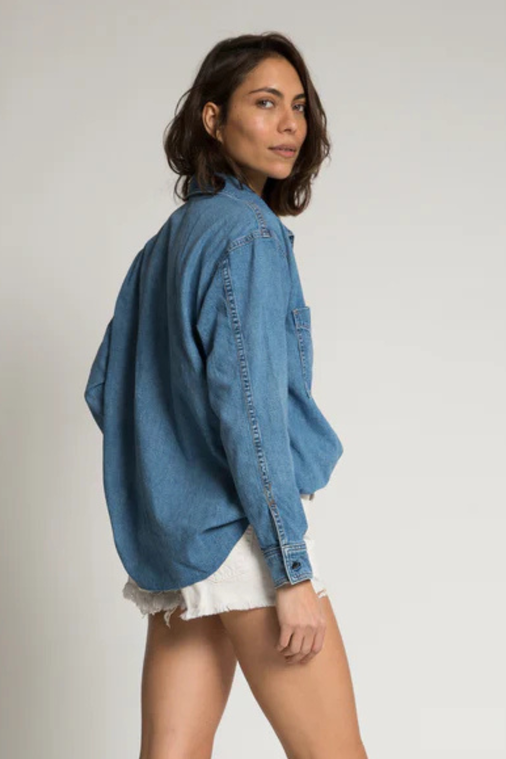 Model wearing ASKK NY Oversized Denim Shirt rear view