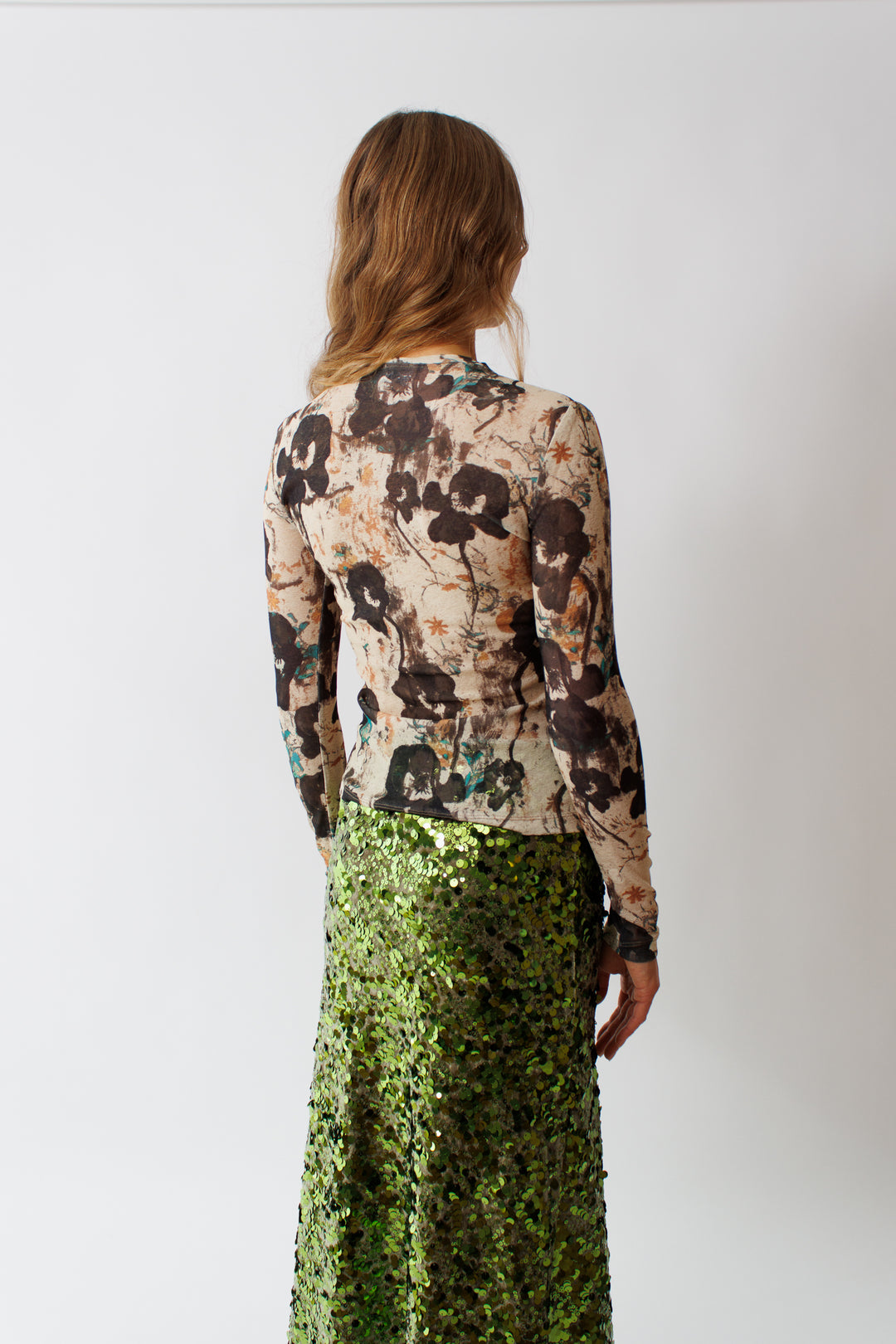 Mari wearing Ganni Printed Marl Mesh Long Sleeve Top rear view