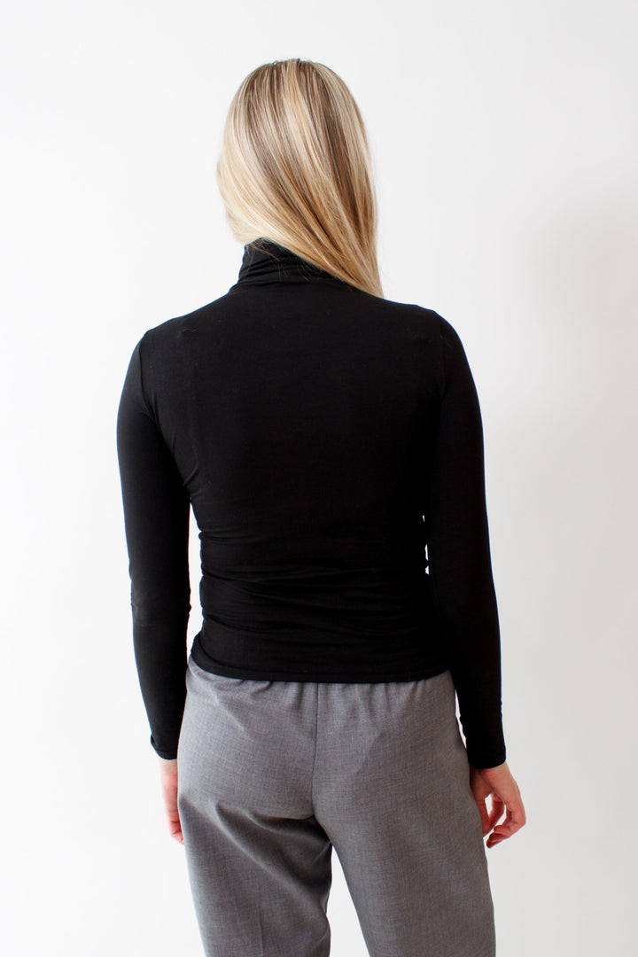 Bailey wearing Pima Cotton Spandex Turtleneck Top Black rear view