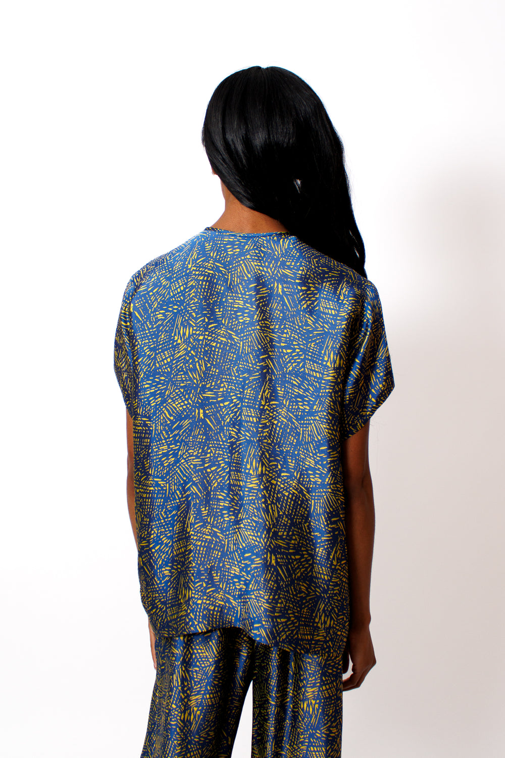 Ja'mes wearing  Zero + Maria Cornejo Rae Crosshatch Jacquard Poncho Top rear view 