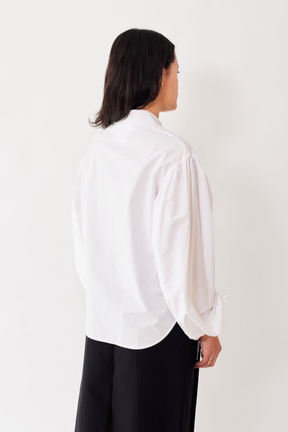 Amanda wearing Mantu Ruched Long Sleeve Button Down Shirt rear view