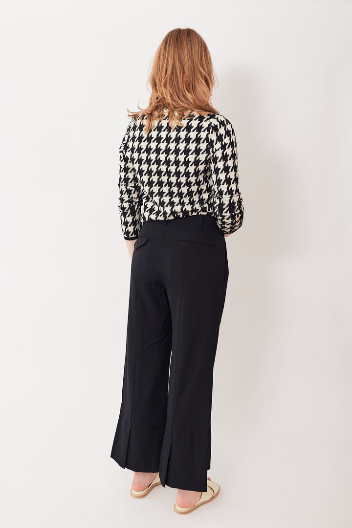 Waverly wearing Comme des Garçons Split Hi Lo Hem Pleated Trouser rear view