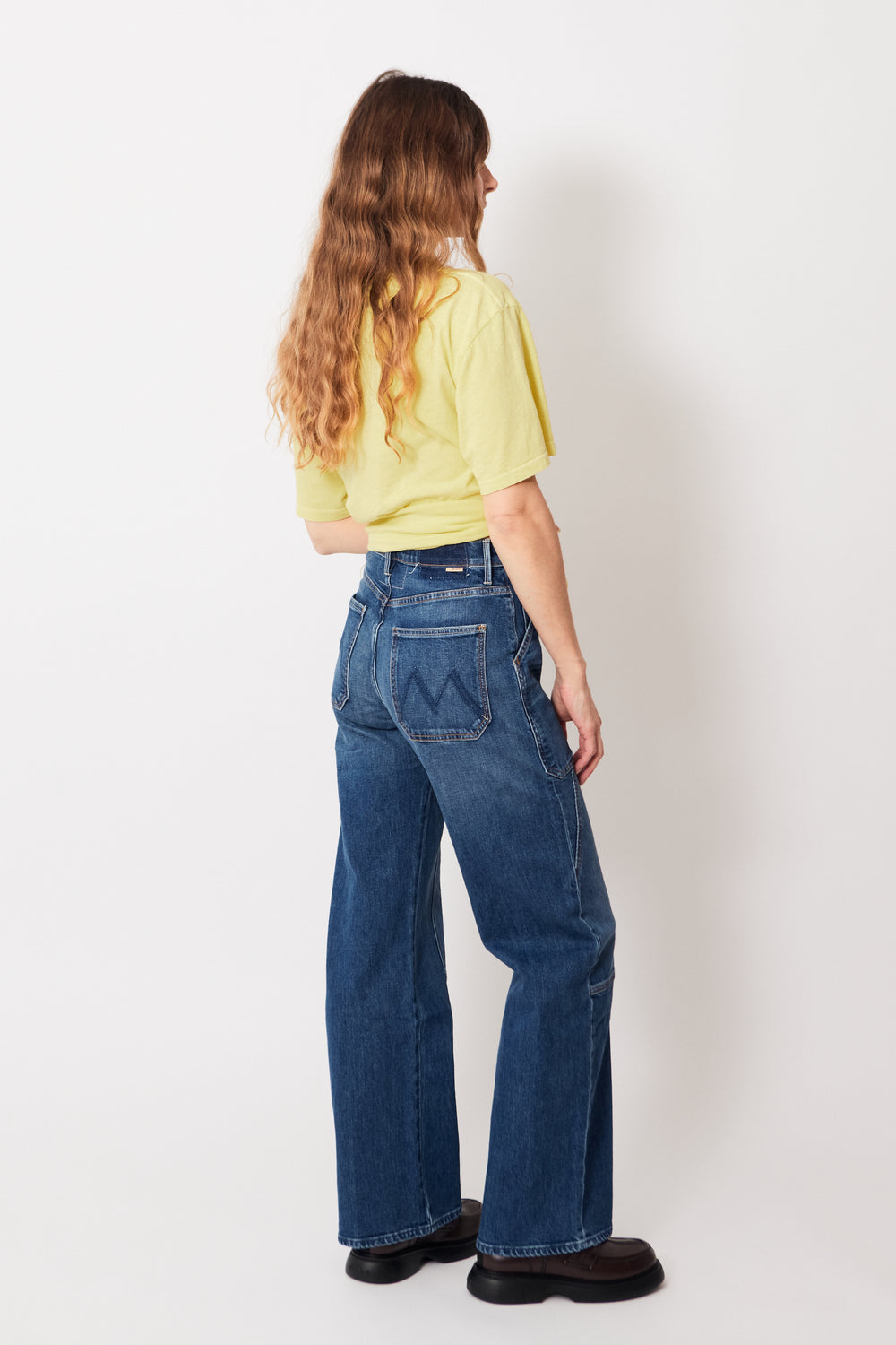 Mari wearing Mother Denim The Lasso Utility Sneak rear view