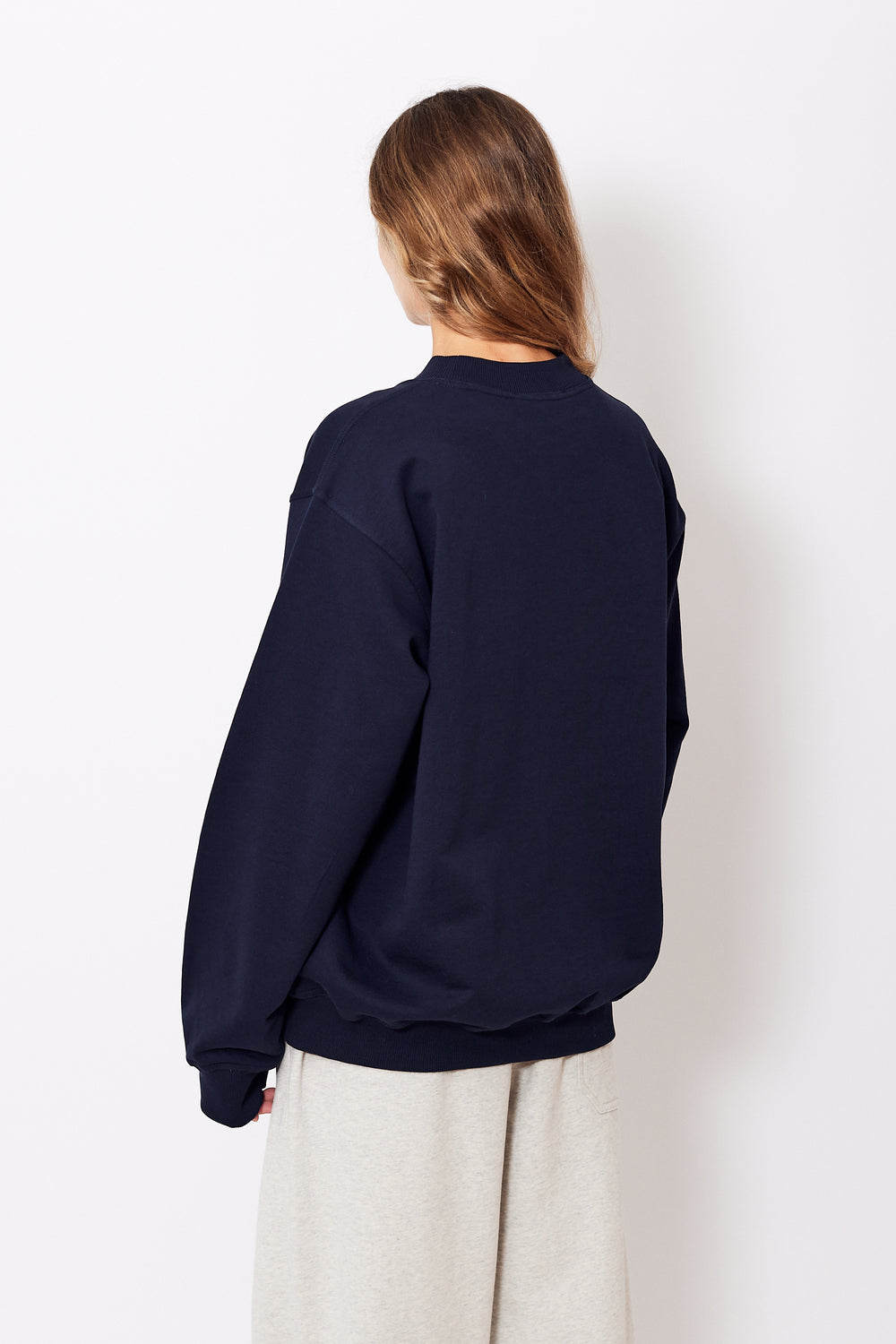 Mari wearing Sofie D'Hoore Tilt Top Stitch Sweatshirt rear view