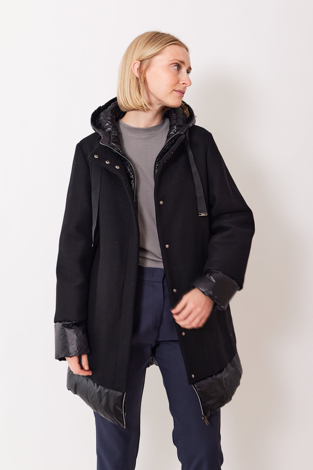 Madi wearing Herno Eco Wool A Shape Coat With Shiny Nylon Hood And Bottom black front view