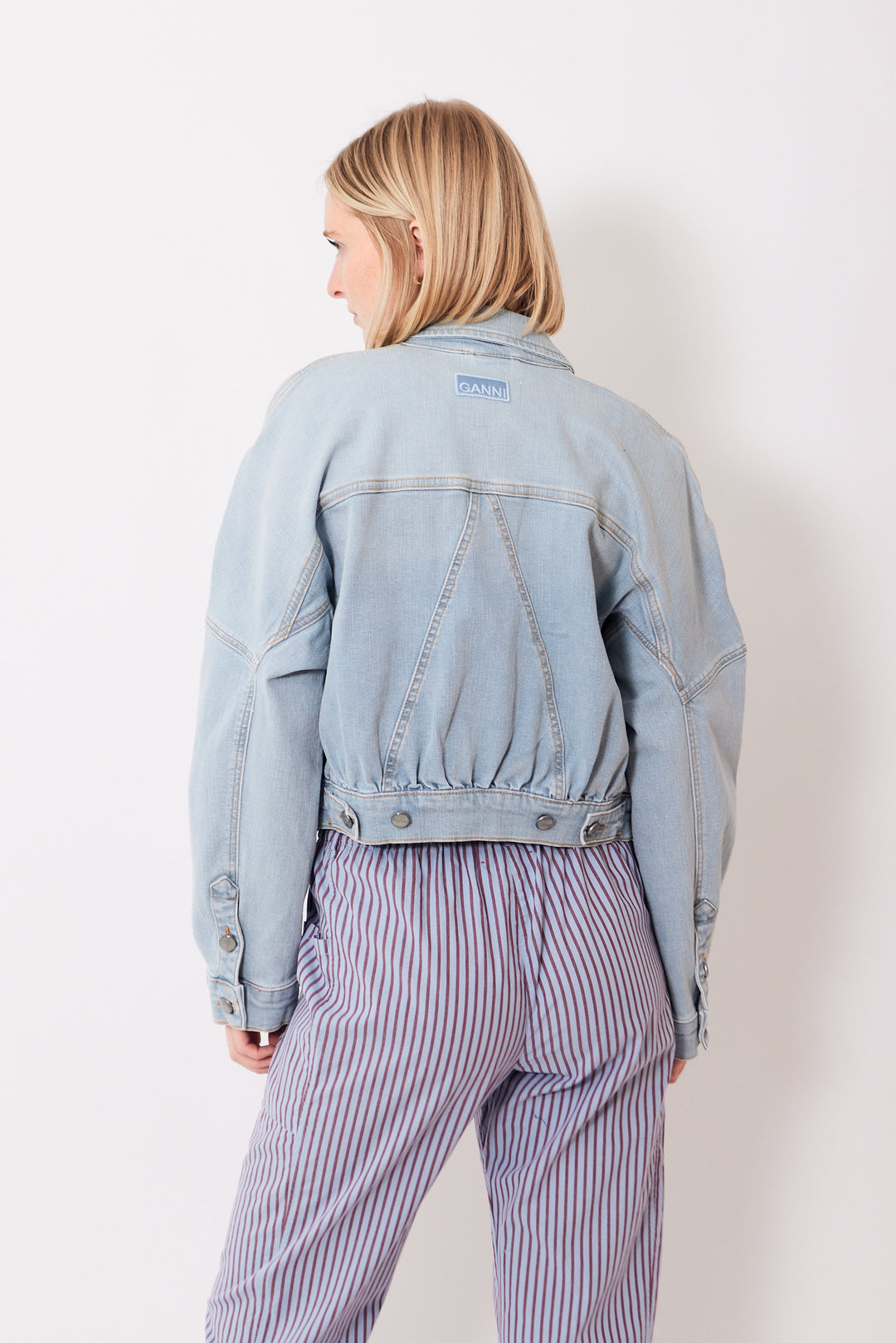 Madi wearing Ganni Tint Denim Bomber Jacket rear view